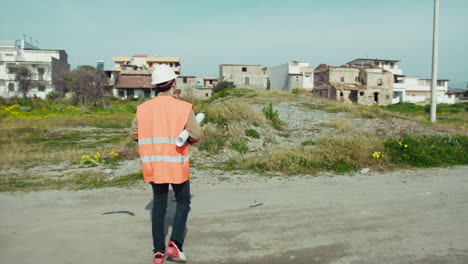 engineer with helmet going towards the building to rebuild
