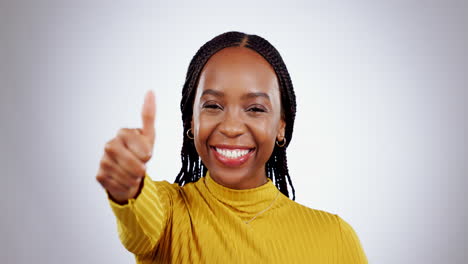 Thumbs-up,-excited-face-and-woman-in-studio