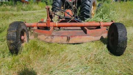 rear view of the unit for mowing grass he is pulled by the tractor