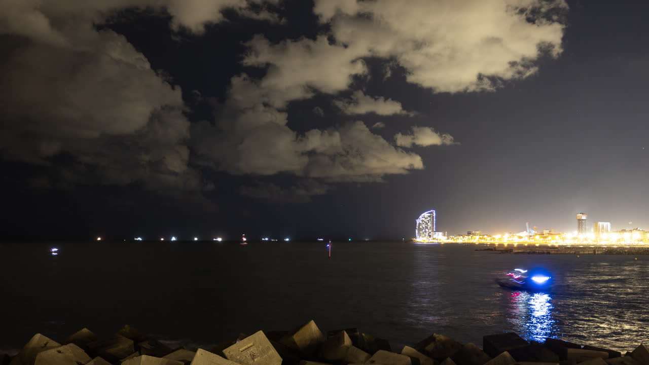 Night cityscape with sea and illuminated buildings