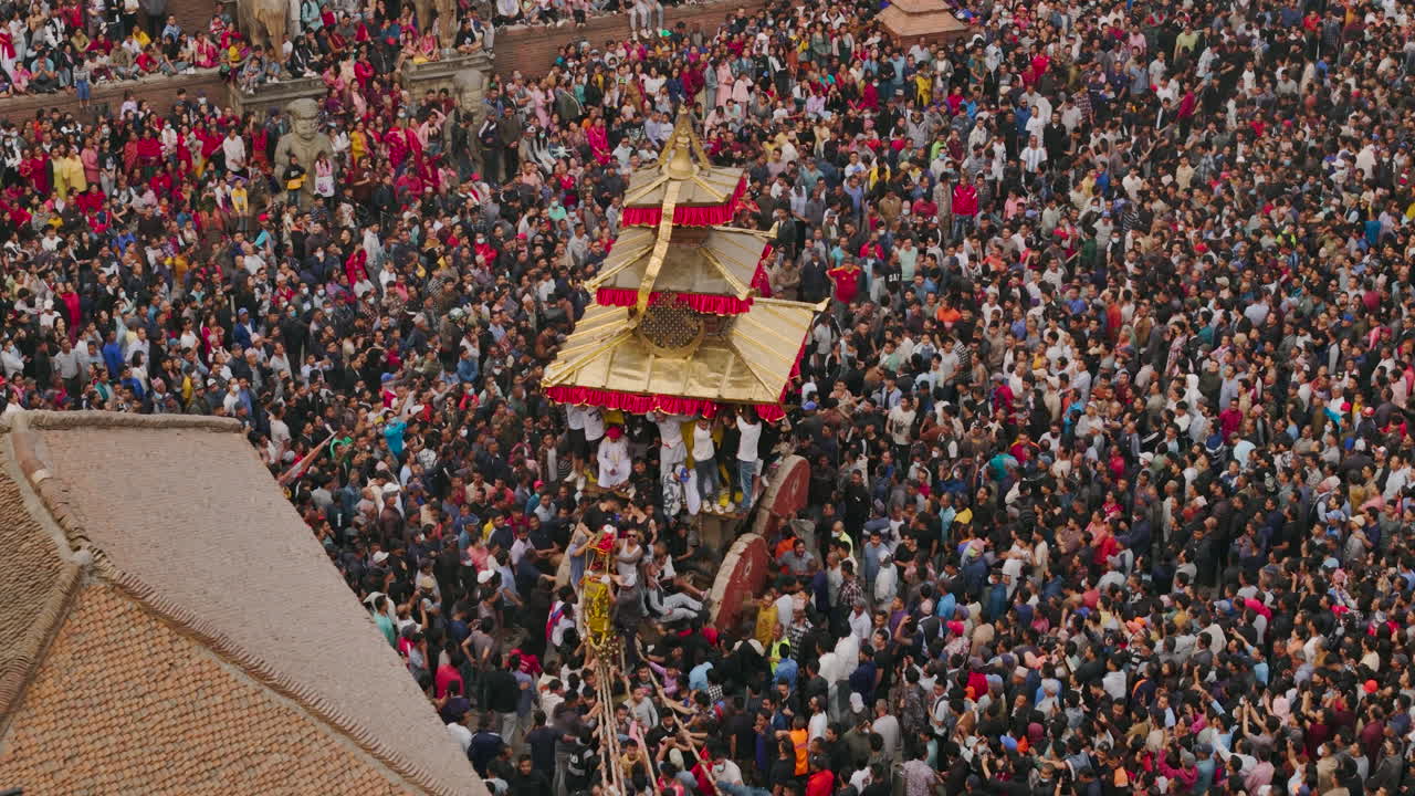 Drone shot of Nyatapole Temple at Bhaktapur Durbar Square during Bisket Jatra festival, capturing unity and celebration of Newari culture as a chariot is pulled amidst festivities rich architectures