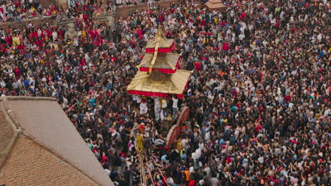 drone shot of nyatapole temple at bhaktapur durbar square during bisket jatra festival, capturing unity and celebration of newari culture as a chariot is pulled amidst festivities rich architectures