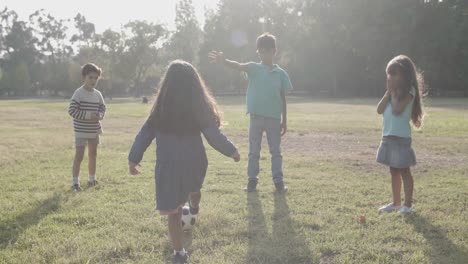 happy kids playing football outdoors