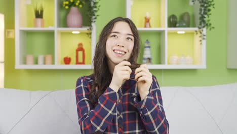 asian young woman looking at her beautiful and attractive hair.