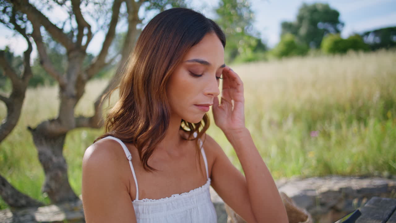 Drinking woman holding smartphone open air closeup. Model sipping orange juice