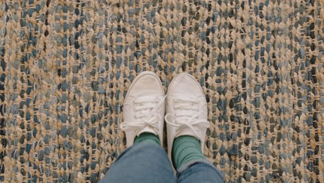 top view woman wearing white shoes enjoying stylish new footware standing on carpet rug