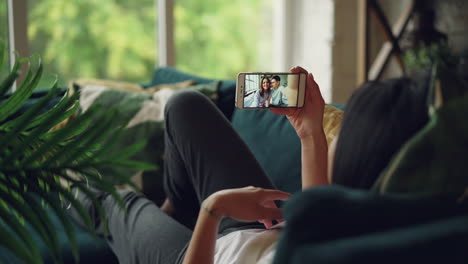 Woman having a video call on her couch