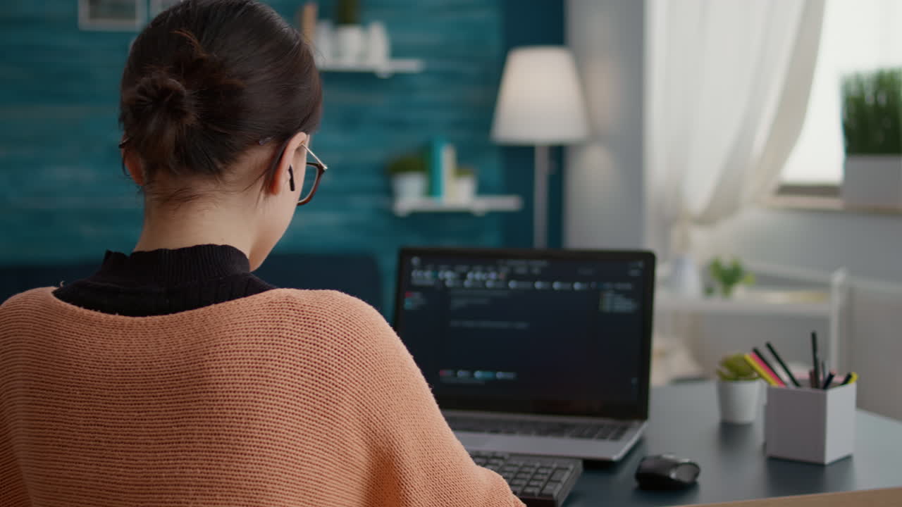 Young adult working on binary code programming at desk