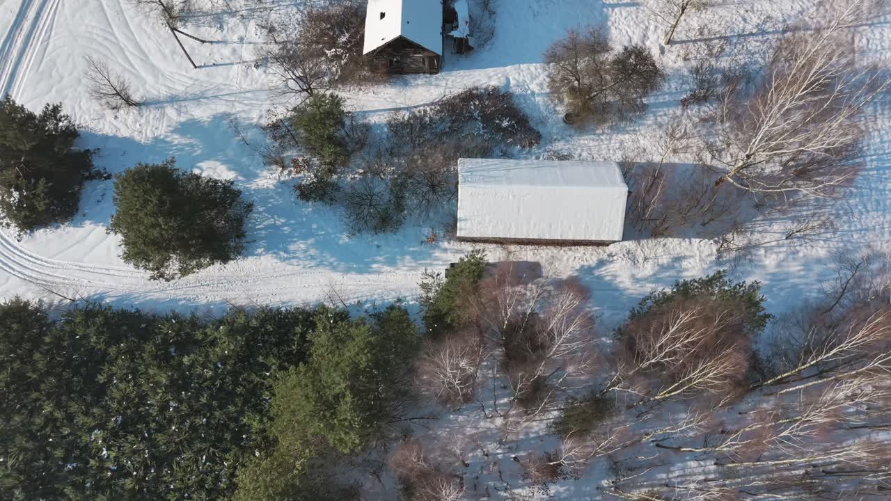 High-angle view of small structures in snowy terrain