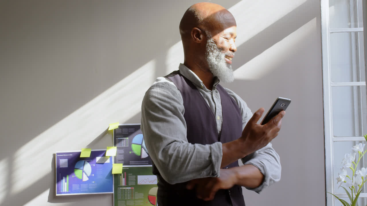 Businessman using mobile phone in office 4k