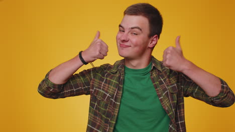 teenager man raises thumbs up agrees or gives positive reply recommends advertisement likes good