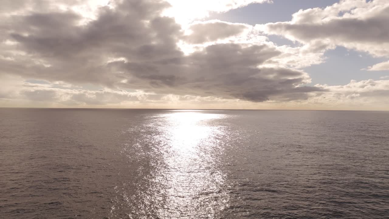 Aerial Drone Flight Toward Golden Sunrise Over Shimmering Ocean – Morning Sky, Horizon Glow, Cloudy Golden Hour Light in Sydney, Australia
