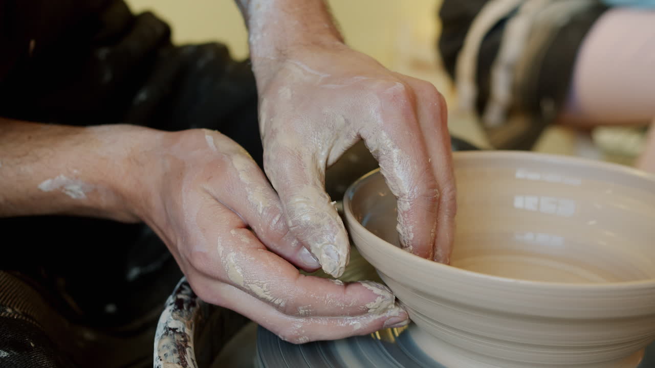 Hands Shaping a Bowl on a Pottery Wheel