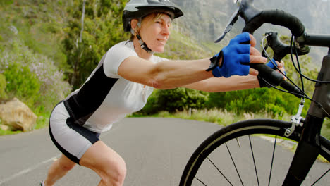 Senior-cyclist-exercising-with-cycle-at-countryside-4k