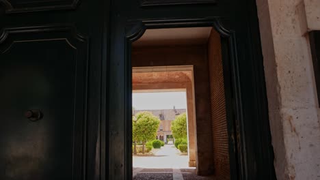 tilt down shot of a wooden gate giving acces to gardens in aranjuez, spain