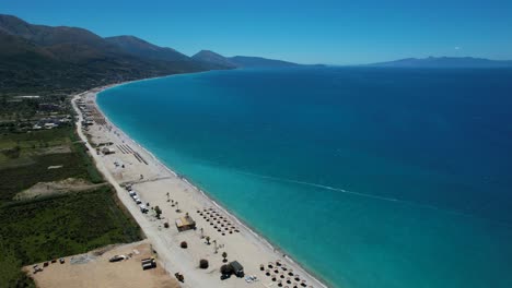 Ionian-Sea-with-Azure-Waters-and-Expansive-Calm-Beach,-Olive-Trees-in-Borsh-Valley:-Tourist-Summer-Destination-in-Albania