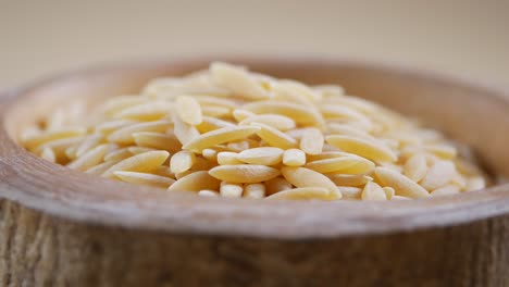 orzo pasta in a wooden bowl