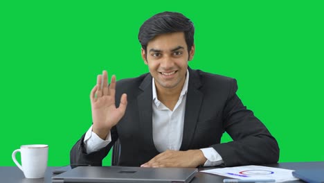 Successful-Indian-business-waving-Hi-to-the-camera-Green-screen