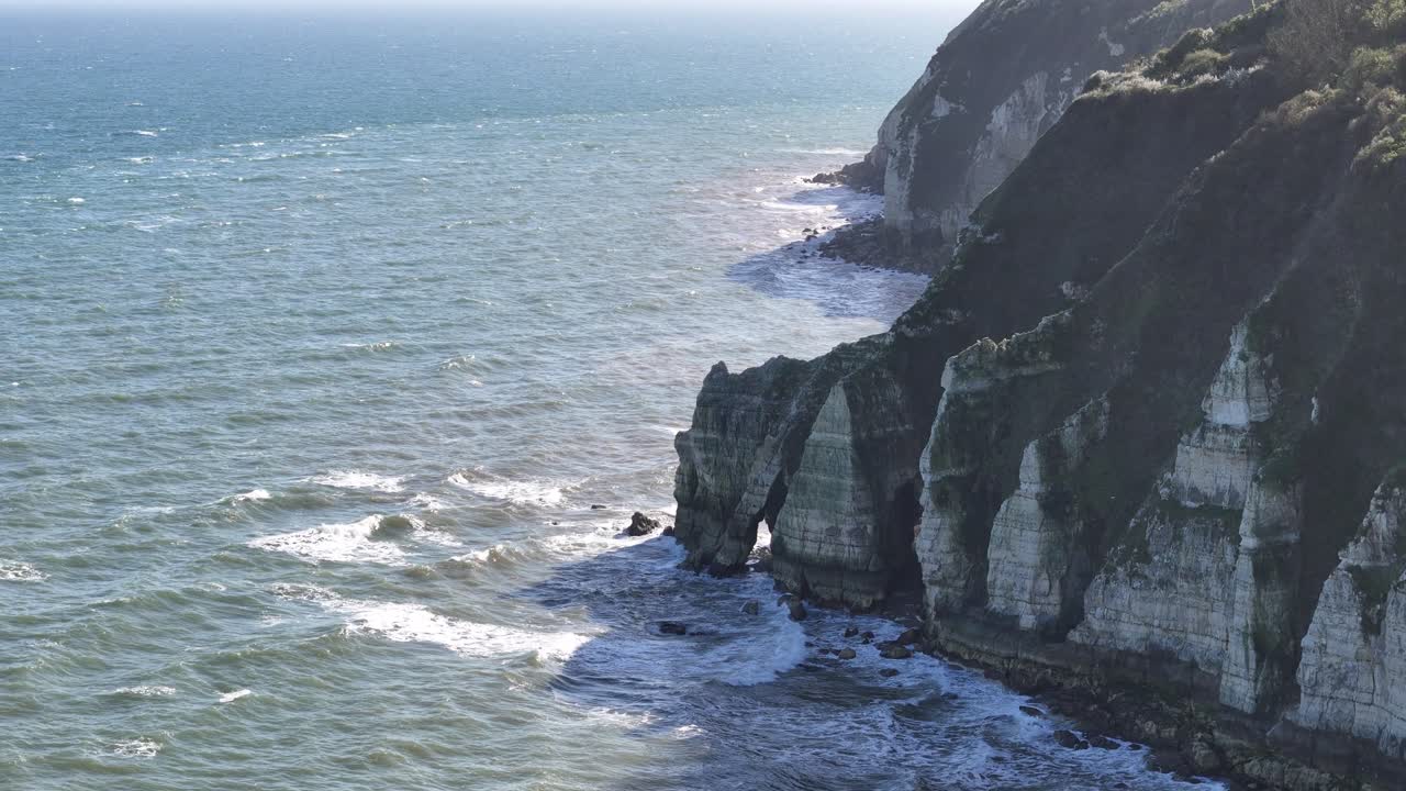Rock arch near seaside Beer village Devon high angle drone aerial view