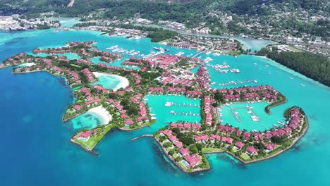 aerial view of a tropical luxury island resort with villas and marina