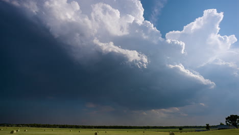 storm clouds over a hay field