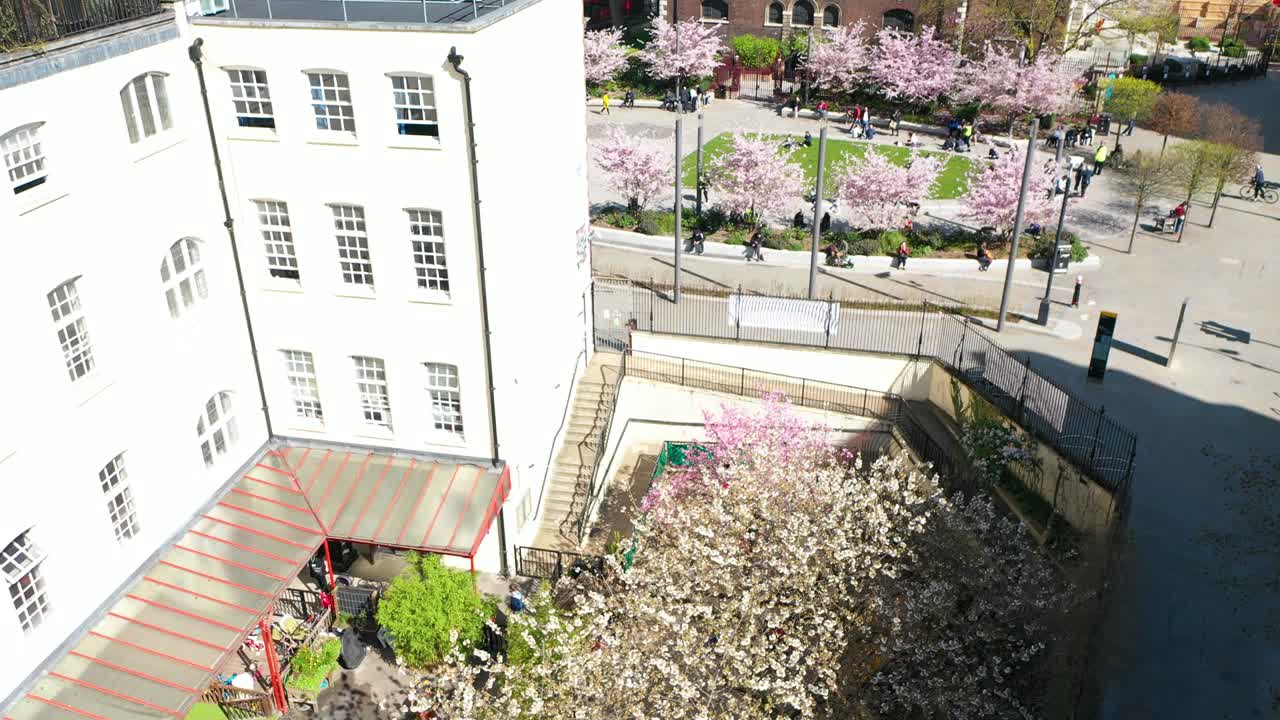 school kids in the school compound tilt down reveal in the city centre