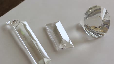 Close-up-rectangular-shaped-beads-of-glass-crystal-in-a-white-background---transparent-crystal-refraction