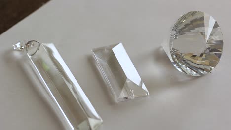 close up rectangular shaped beads of glass crystal in a white background - transparent crystal refraction