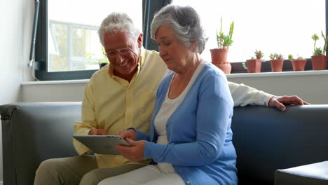 senior couple using digital tablet