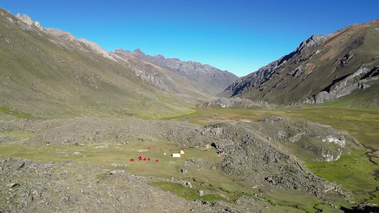Mountain alpine camp set up by glacial moraine in Huayhuash mtns, Peru