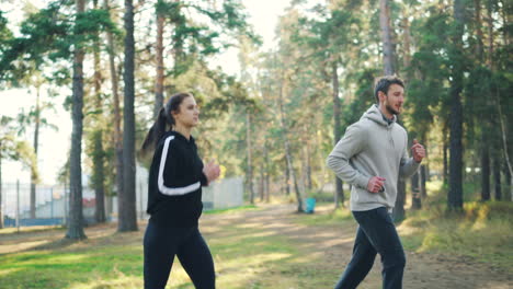 couple jogging in a forest park