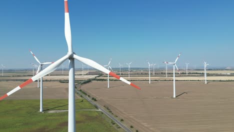 Wind-turbines-creating-renewable-energy-on-a-clear-day,-view-of-energy-windmill-turbines,-still-shot