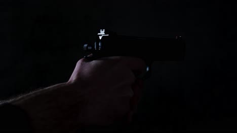 9mm pistol shooting multiple times until it is empty in a dark room