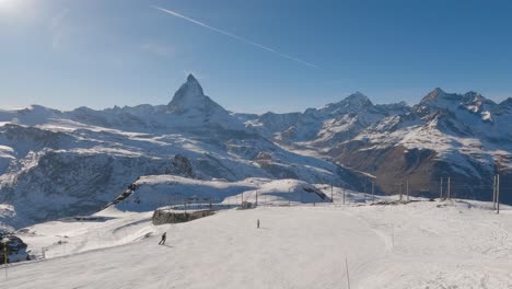 people skiing down mountain on beautiful winter day