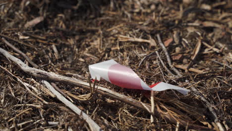 red and white striped tape blowing in the wind marking a pre-construction terrain - high angle close up