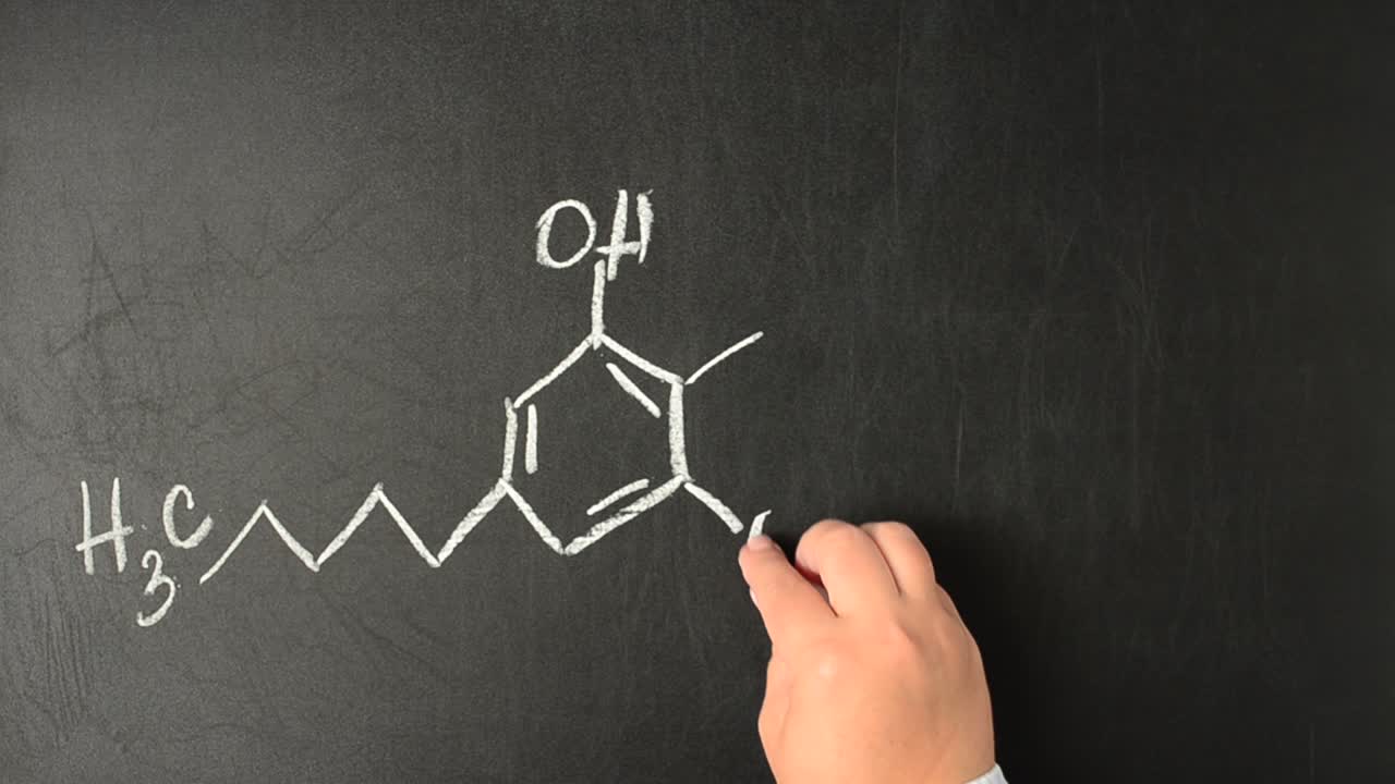Tetraidrocannabinolo e la sua formula chimica disegnata. Modello strutturale della molecola di THC sulla lavagna