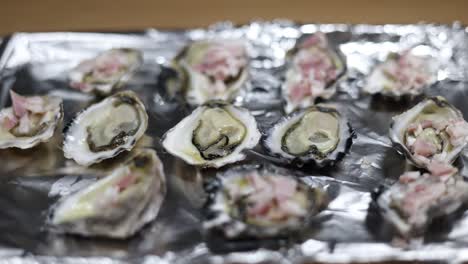 sequential display of oysters being prepared on foil