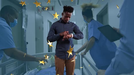 animation of stars and african american man with smartwatch over diverse doctors