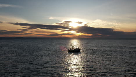 aerial drone view circling around a fishing boat