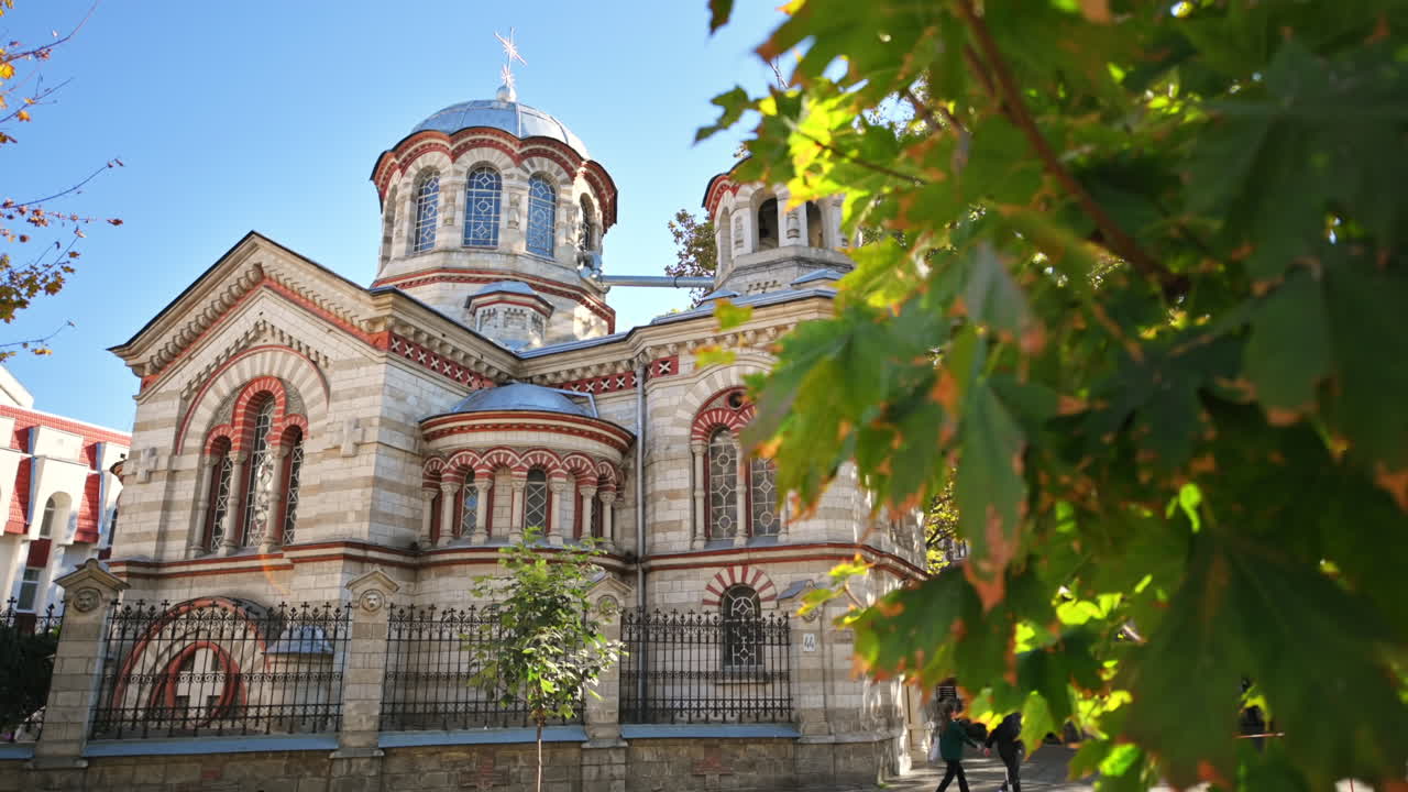 Saint Panteleimon Church in Chisinau, Moldova. Facade and court, yellowing trees around it