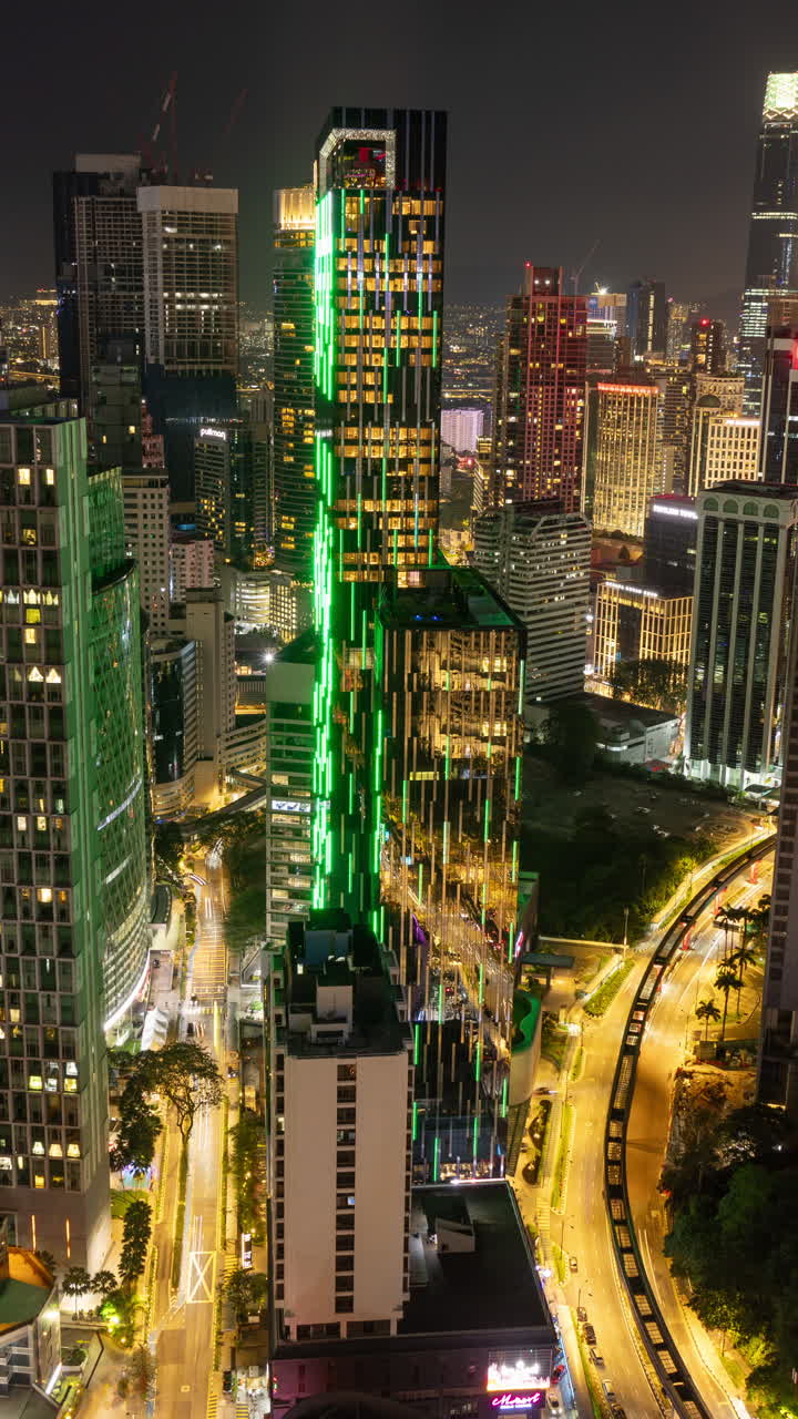 KUALA LUMPUR - 29 MARCH 2025 : Timelapse of the Kuala Lumpur skyline from a high vantage point in vertical at night