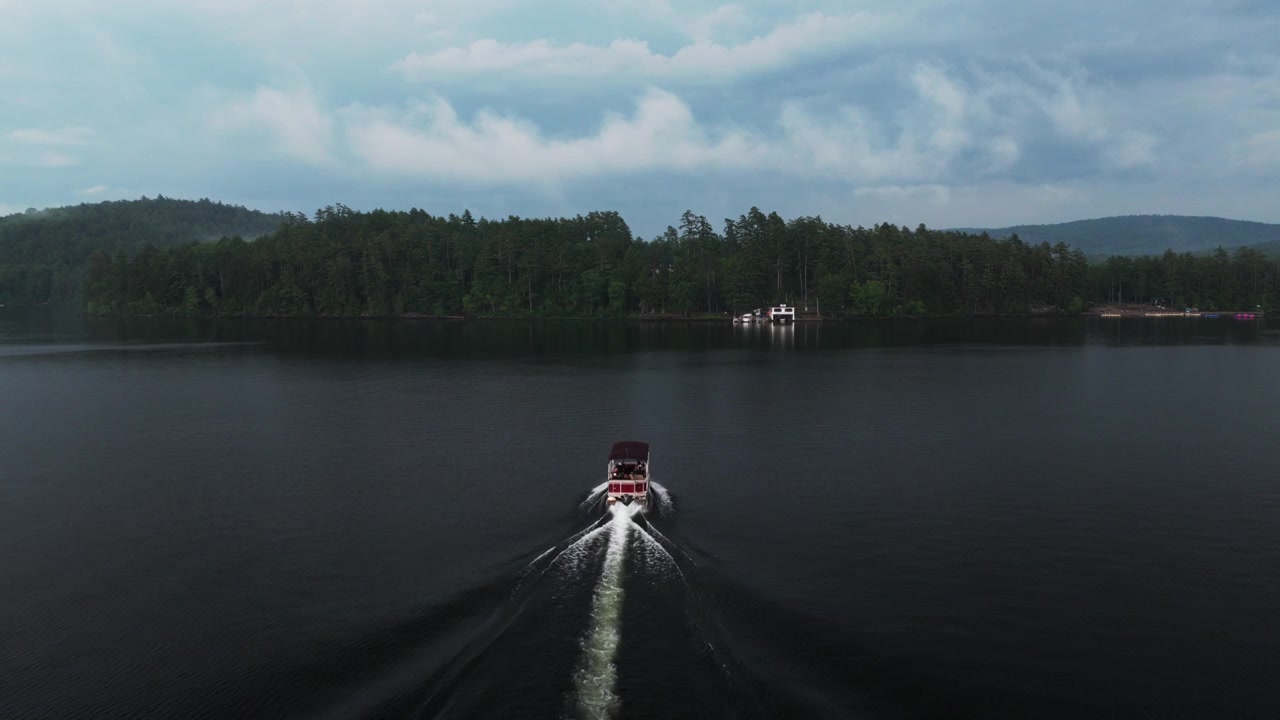 Boating ferry ride Lake Schroon Clarks Island WOL dock rainy mist clouds sunset aerial drone Town of Schroon Lake Up State New York Adirondack Mountains harbor view landscape summertime forward follow