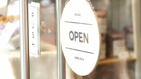 open sign hanging front of cafe