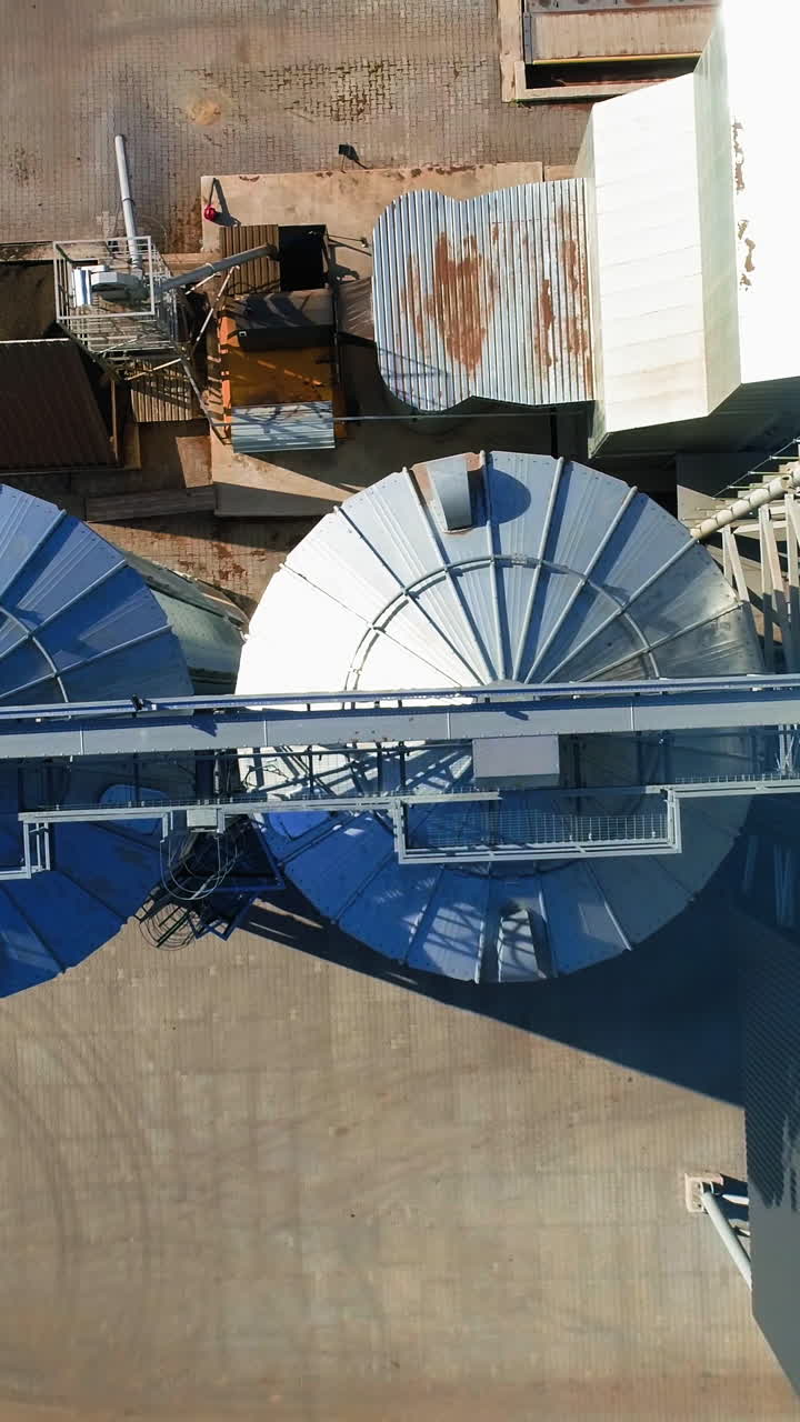 Grain Cooperative. Large aluminum containers for storing loose grain. Aerial view Vertical video