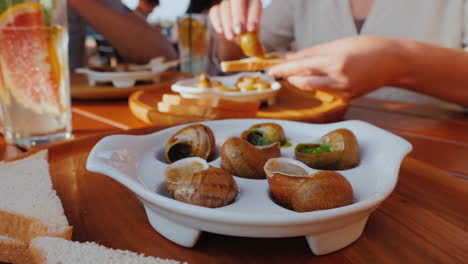 a man eats an exquisite dish of snails 1