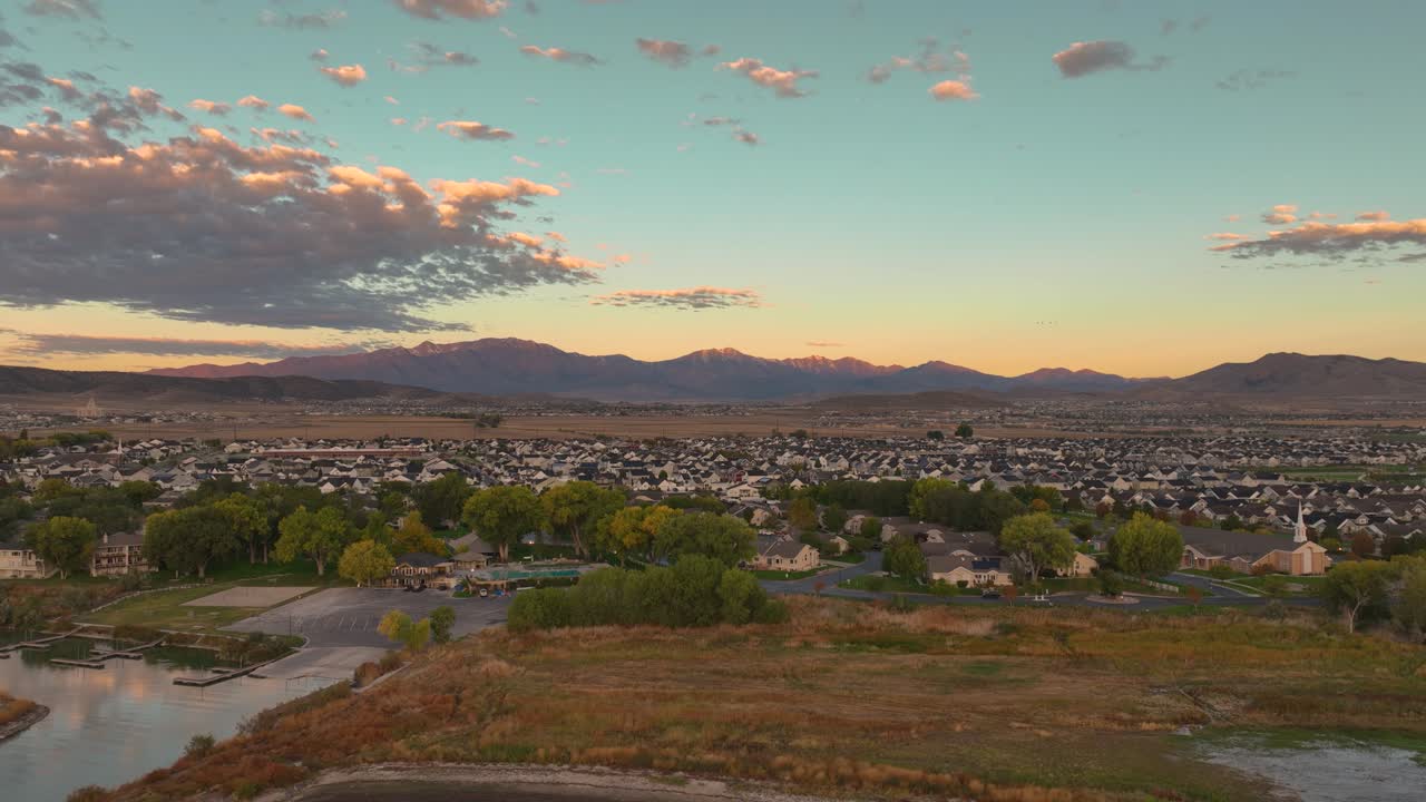 Pullback Aerial View Of Private Marina And City Of Saratoga Springs Revealing Utah Lake At Sunrise, USA