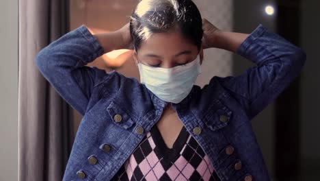 a young girl wearing a mask in a office hall