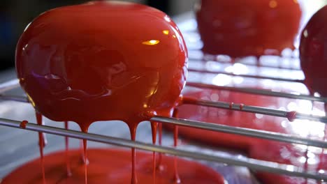 red glazed cakes on cooling rack