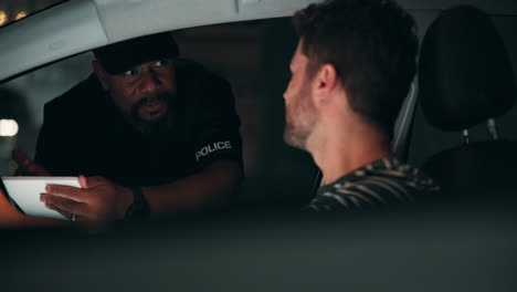 a police officer conducts a traffic stop at night