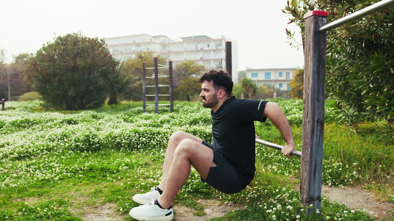 Man Working Out Surrounded By The Green Of The City Park